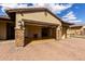 Large two car attached garage with stone column accents at 7630 E Knoll St, Mesa, AZ 85207