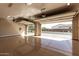 Bright and spacious three-car garage, featuring an open garage door and epoxy floors at 7630 E Knoll St, Mesa, AZ 85207