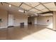 Spacious three car garage featuring epoxy floors, neutral paint, and ample storage space at 7630 E Knoll St, Mesa, AZ 85207