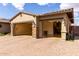 Attached three car garage featuring stone column accents and epoxy floors at 7630 E Knoll St, Mesa, AZ 85207