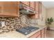 Kitchen features stainless steel hood and a mosaic tile backsplash enhancing the granite countertop at 7630 E Knoll St, Mesa, AZ 85207