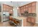 Spacious kitchen island with seating, stainless steel appliances, and pendant lighting create a modern culinary space at 7630 E Knoll St, Mesa, AZ 85207