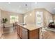 A kitchen island with granite countertops and stainless steel appliances stands out in this space at 7630 E Knoll St, Mesa, AZ 85207