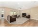 Comfortable living room with hardwood and carpet flooring, ceiling fan and recessed lighting at 7630 E Knoll St, Mesa, AZ 85207