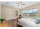 Bright and airy bedroom featuring hardwood floors, a ceiling fan, and large windows with backyard views at 7630 E Knoll St, Mesa, AZ 85207