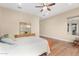 Serene bedroom with wood floors, a plush bed, and abundant natural light from a large window at 7630 E Knoll St, Mesa, AZ 85207