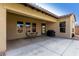 Covered patio with outdoor seating area and a barbecue grill, perfect for entertaining guests at 7630 E Knoll St, Mesa, AZ 85207