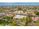 Expansive aerial view showcases the desert home with a pool, palm trees and mountains in the distance at 7719 W Bluefield Ave, Glendale, AZ 85308