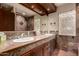 Bathroom featuring tiled walls, double sinks with tiled countertop and wood cabinets at 7719 W Bluefield Ave, Glendale, AZ 85308