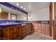 Charming bathroom featuring brick floors, blue tile counters and walls, and wooden cabinets at 7719 W Bluefield Ave, Glendale, AZ 85308