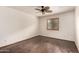 Neutral bedroom with wood-look floors, simple window, and ceiling fan at 7719 W Bluefield Ave, Glendale, AZ 85308