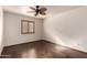 Well-lit bedroom featuring hardwood floors, ceiling fan, and a window with shutters at 7719 W Bluefield Ave, Glendale, AZ 85308