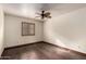 Bedroom with hardwood floors, ceiling fan, and shutters on the windows at 7719 W Bluefield Ave, Glendale, AZ 85308