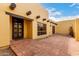 Front of house courtyard displays Saltillo tile, rustic wooden beam accents and an ornate iron gate at 7719 W Bluefield Ave, Glendale, AZ 85308