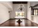 Dining room features wood floors, a large window with a view, and a chandelier fixture at 7719 W Bluefield Ave, Glendale, AZ 85308