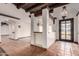 Inviting entryway boasts decorative lighting, a terra cotta tile floor, and wooden beam architectural features at 7719 W Bluefield Ave, Glendale, AZ 85308