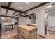 Spacious kitchen features butcher block island, custom cabinets, and terra cotta tile flooring at 7719 W Bluefield Ave, Glendale, AZ 85308