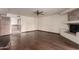 Open living room featuring hardwood floors, a fireplace, and access to the bathroom at 7719 W Bluefield Ave, Glendale, AZ 85308