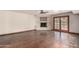 Bright living room features a fireplace, hardwood floors, and French doors to an outdoor patio at 7719 W Bluefield Ave, Glendale, AZ 85308