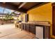 Covered outdoor kitchen with grill, sink, refrigerator, and countertop space at 7719 W Bluefield Ave, Glendale, AZ 85308