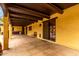 Covered patio with stucco walls, dark wood accents, and an outdoor kitchen at 7719 W Bluefield Ave, Glendale, AZ 85308