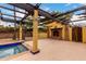 Backyard pool area with outdoor fireplace, pergola, and spacious patio at 7719 W Bluefield Ave, Glendale, AZ 85308