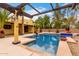 Backyard pool area with lush landscaping and a covered patio area at 7719 W Bluefield Ave, Glendale, AZ 85308