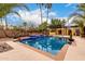 Outdoor pool with a waterfall feature, a built-in barbecue, and lush landscaping at 7719 W Bluefield Ave, Glendale, AZ 85308