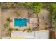 Aerial shot features the backyard pool area with pergola, palm trees and lush desert landscaping at 7719 W Bluefield Ave, Glendale, AZ 85308