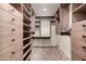 Walk-in closet with custom shelving and ample storage space at 7719 W Bluefield Ave, Glendale, AZ 85308