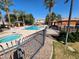 Resort-style community pool and spa area complete with palm trees and lounge chairs for relaxation at 8527 E Lindner Ave, Mesa, AZ 85209