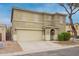 Two-story home with tan stucco, two car garage, covered front porch, and partial bare tree in the front yard at 8527 E Lindner Ave, Mesa, AZ 85209