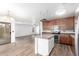 Open-concept kitchen showcasing stainless steel appliances, island, and view into the adjacent living room at 8527 E Lindner Ave, Mesa, AZ 85209