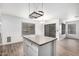 Bright eat-in kitchen featuring a center island, modern lighting, and view into the adjacent living room at 8527 E Lindner Ave, Mesa, AZ 85209