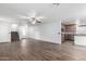 Spacious living room featuring wood-look floors, staircase, and open access to the adjacent kitchen at 8527 E Lindner Ave, Mesa, AZ 85209