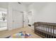 Bedroom featuring a crib and closet, with an additional room visible through the doorway at 8832 E Wethersfield Rd, Scottsdale, AZ 85260