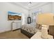 Well-lit bedroom with modern furnishings, carpet, and large window with shutters at 8832 E Wethersfield Rd, Scottsdale, AZ 85260