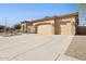 Spacious garage with stone accents and a large driveway at 8832 E Wethersfield Rd, Scottsdale, AZ 85260