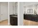 Elegant hallway showcases sleek dark cabinets and hardwood flooring at 8832 E Wethersfield Rd, Scottsdale, AZ 85260