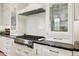 Close-up of modern kitchen details including stainless steel appliances, cabinetry, and backsplash at 8832 E Wethersfield Rd, Scottsdale, AZ 85260