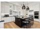 Modern kitchen featuring white cabinetry, stainless appliances and a dark island with seating at 8832 E Wethersfield Rd, Scottsdale, AZ 85260