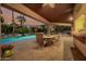 Inviting outdoor dining area with a pool view, offering a perfect blend of relaxation and entertainment at 8924 E Charter Oak Dr, Scottsdale, AZ 85260