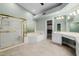 Well-lit bathroom featuring a glass shower enclosure, soaking tub, and vanity with ample counter space at 8924 E Charter Oak Dr, Scottsdale, AZ 85260