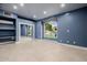 Blue bedroom with mirrored closet doors and a arched window, providing natural light at 8924 E Charter Oak Dr, Scottsdale, AZ 85260