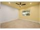 Bright bedroom featuring a ceiling fan, neutral tile flooring, and a window for natural light at 8924 E Charter Oak Dr, Scottsdale, AZ 85260