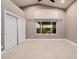 Bright bedroom with a vaulted ceiling, large window, and spacious closet at 8924 E Charter Oak Dr, Scottsdale, AZ 85260