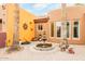 Courtyard featuring a decorative fountain, terracotta roof, and lush desert landscaping at 8924 E Charter Oak Dr, Scottsdale, AZ 85260