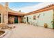 Beautiful courtyard with green walls, terracotta roof, potted plants, and decor at 8924 E Charter Oak Dr, Scottsdale, AZ 85260