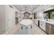 Open kitchen with central island, white cabinetry, tiled floor and stainless steel dishwasher at 8924 E Charter Oak Dr, Scottsdale, AZ 85260