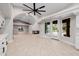 Living space with fireplace, tiled floors, arched openings and backyard access from kitchen at 8924 E Charter Oak Dr, Scottsdale, AZ 85260